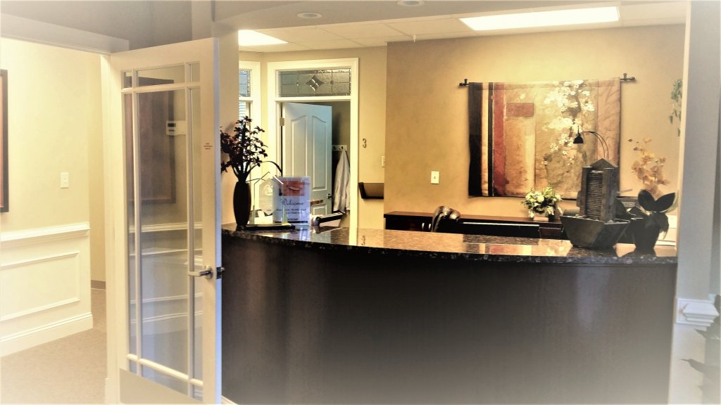 reception desk, with flowers and art on back wall