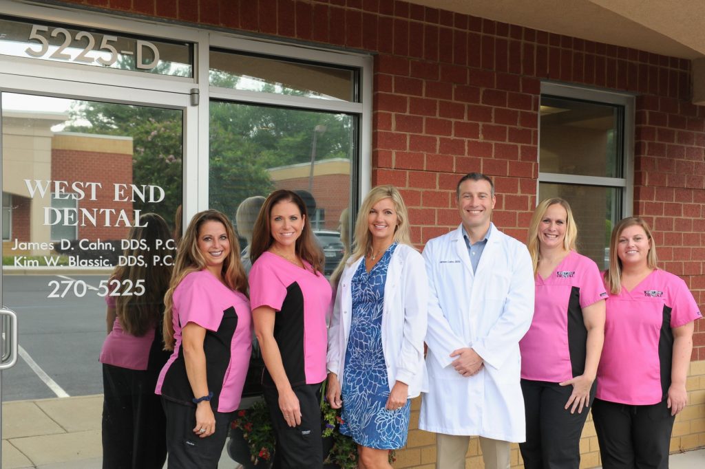 Office team standing outside office